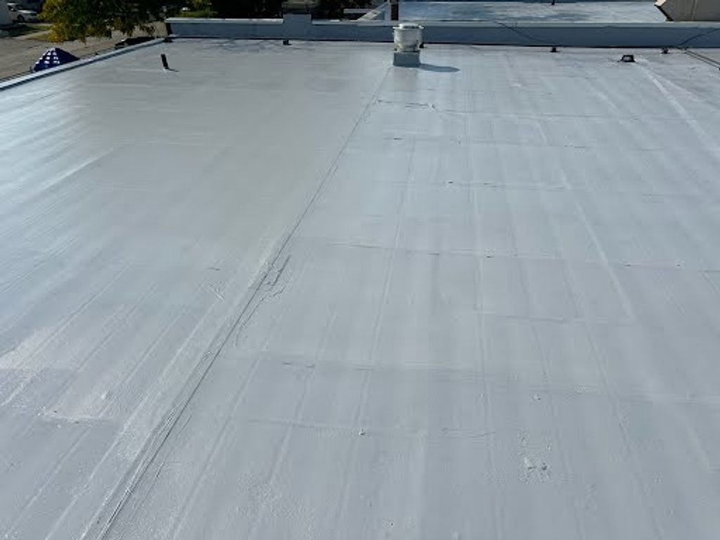 Wide silver-coated flat roof on a commercial building